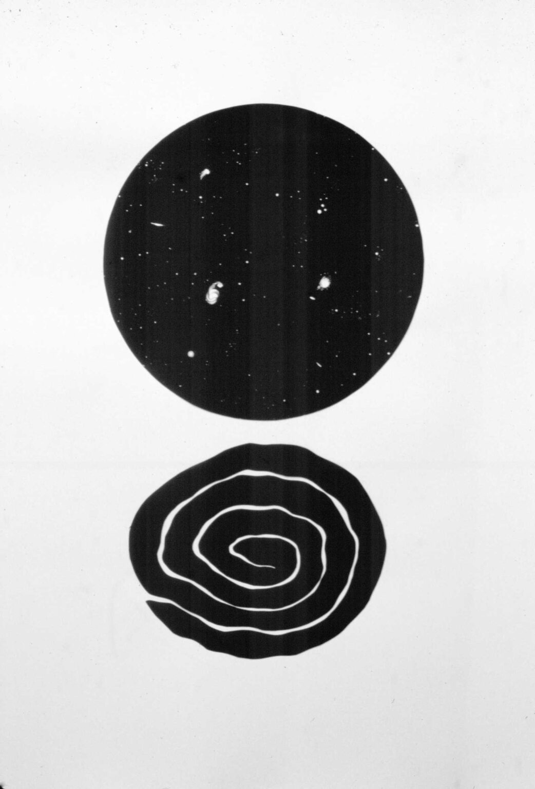 Abstract black and white shapes with a spiral and a dotted circle.