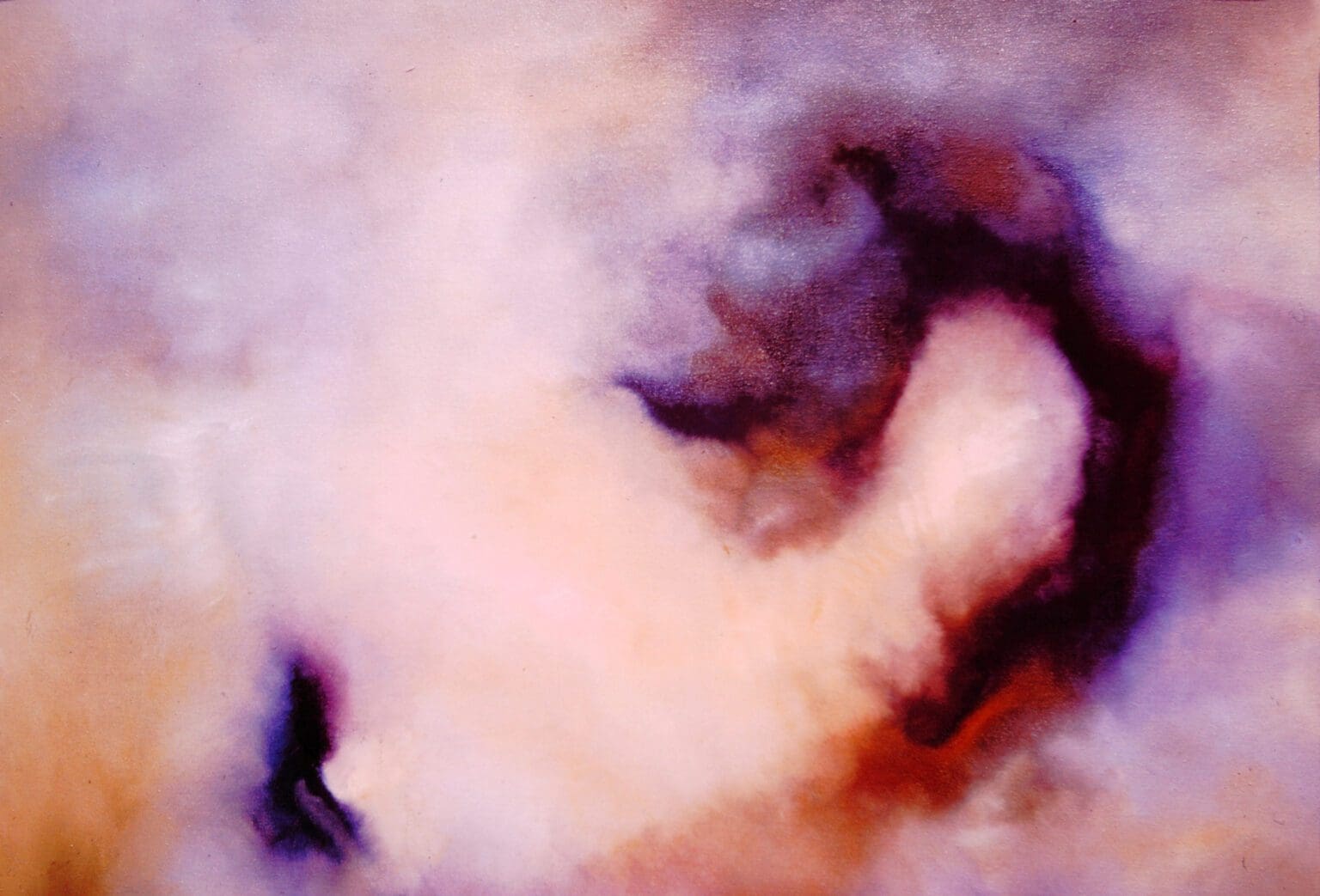 A close-up of a nebula with swirling clouds of gas and dust.
