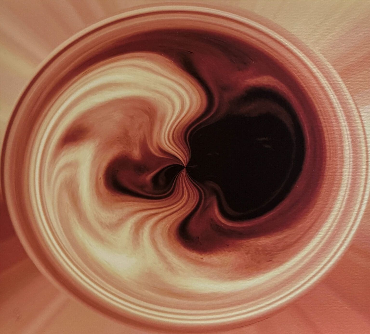 Swirling abstract pattern in warm brown and beige tones.