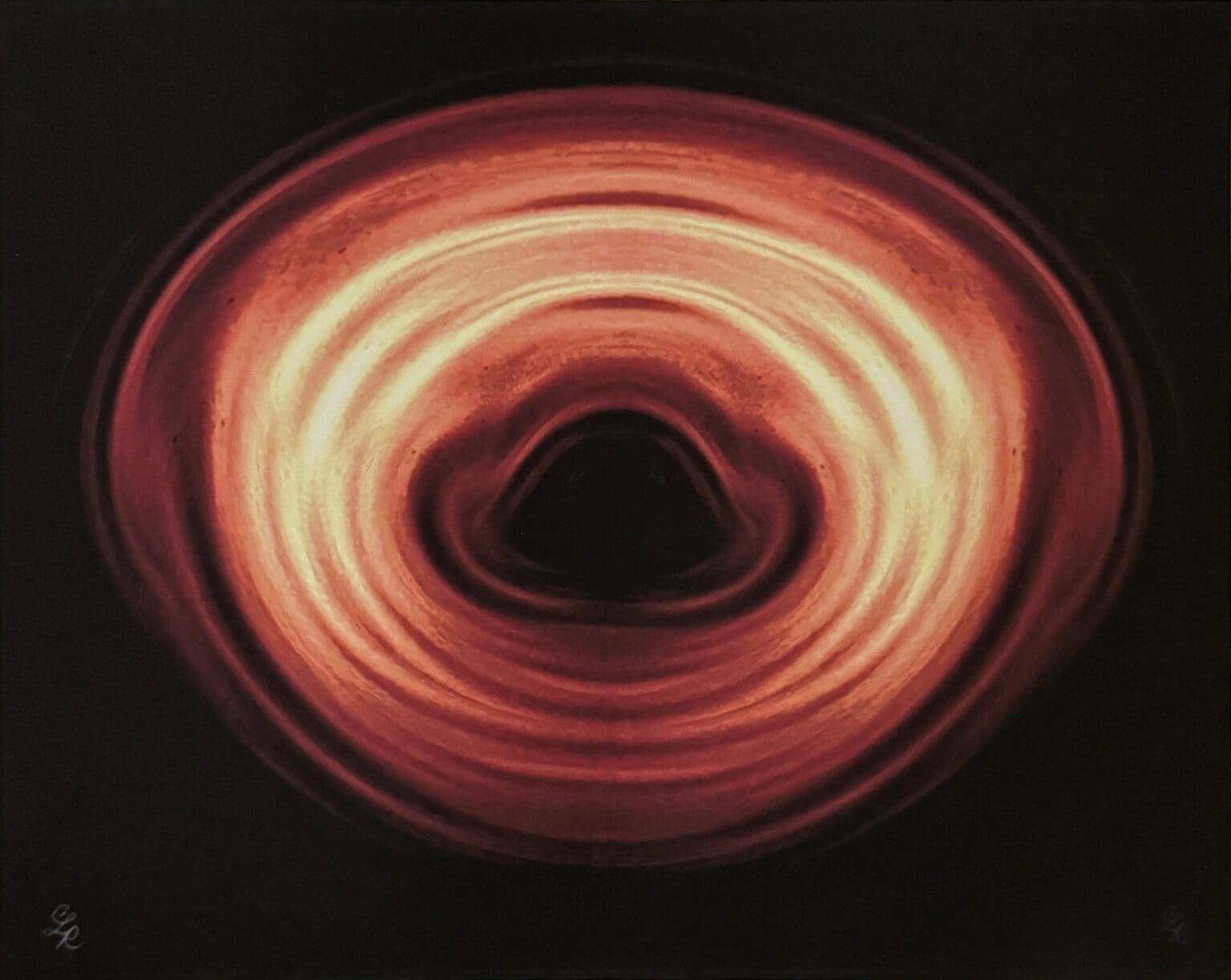 Glowing orange concentric rings around black center